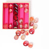 A great selection of various pink glass marbles and pebbles in a pink themed box | © Conscious Craft